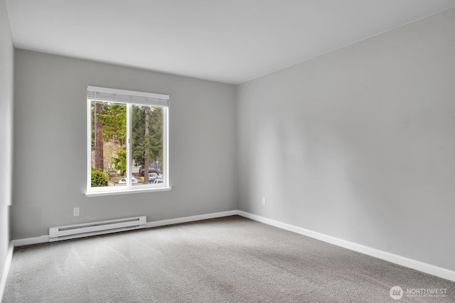 empty room with a baseboard heating unit, carpet, and baseboards