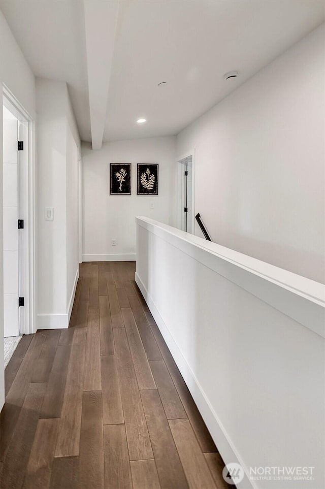 hallway featuring baseboards, dark wood-style flooring, and recessed lighting