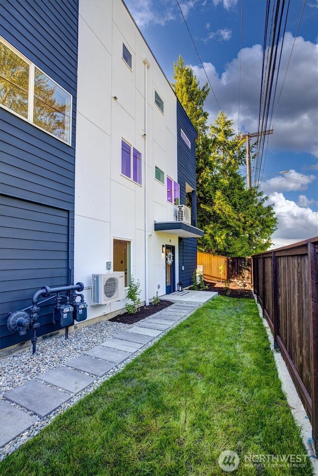 view of yard with ac unit and fence