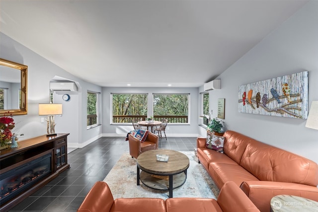 living area featuring dark tile patterned floors, baseboards, an AC wall unit, and recessed lighting