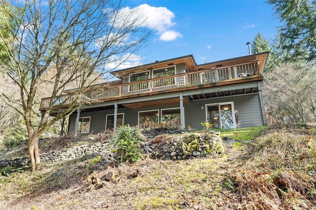 rear view of property with a wooden deck