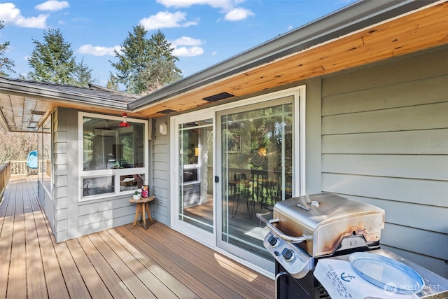 wooden deck featuring a grill