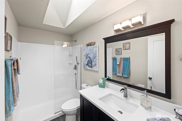 full bathroom with a textured wall, vanity, toilet, and walk in shower