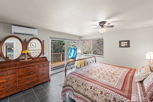 bedroom with ceiling fan, dark tile patterned floors, a wall mounted air conditioner, and access to exterior