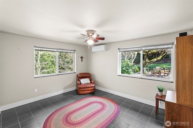 sitting room featuring tile patterned flooring, an AC wall unit, a healthy amount of sunlight, and baseboards