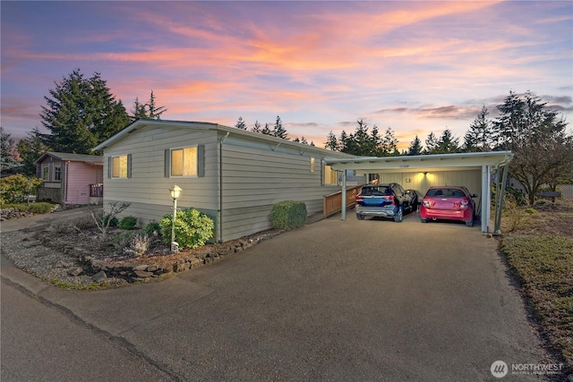 view of front of property featuring a carport and driveway