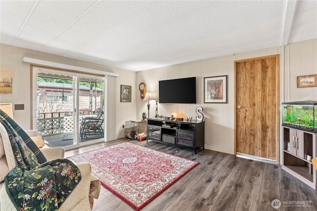 living room with a textured ceiling and wood finished floors