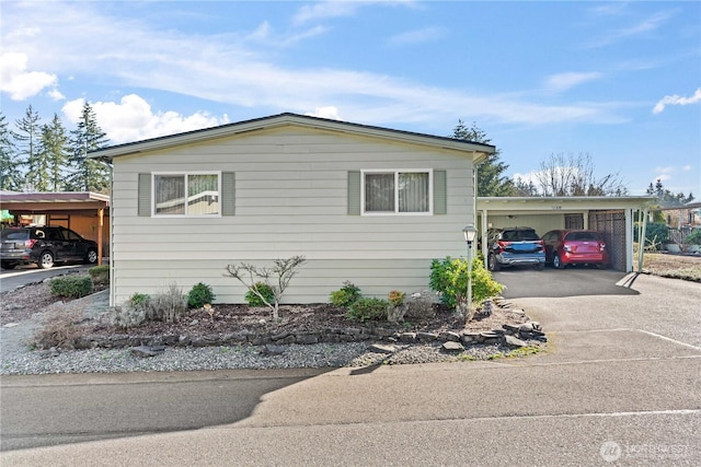 view of front of home featuring aphalt driveway and an attached carport