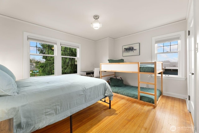 bedroom featuring hardwood / wood-style flooring and baseboards