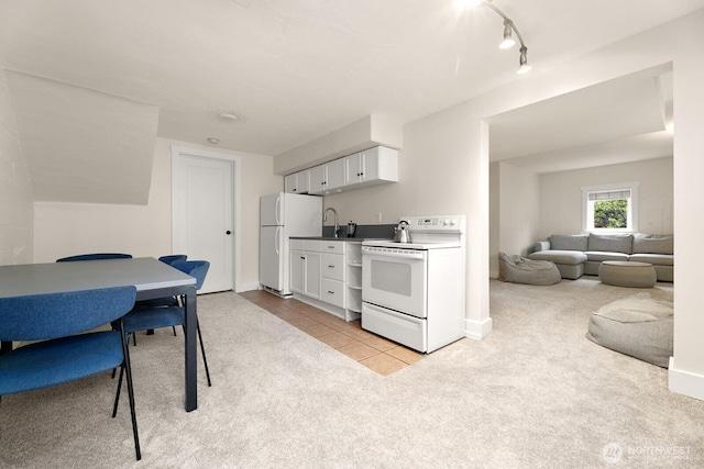 kitchen featuring light tile patterned floors, light colored carpet, open floor plan, white cabinets, and white appliances