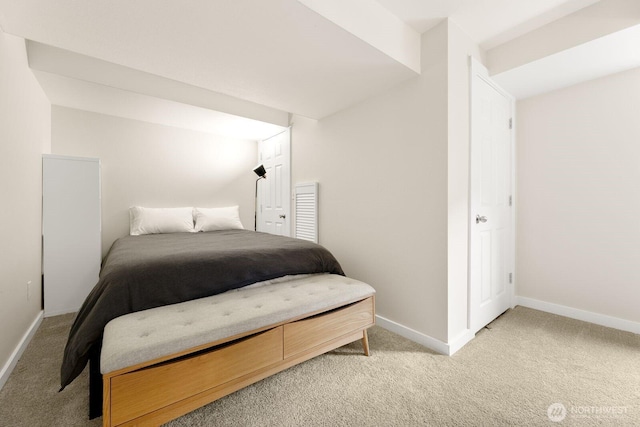 bedroom featuring light carpet and baseboards