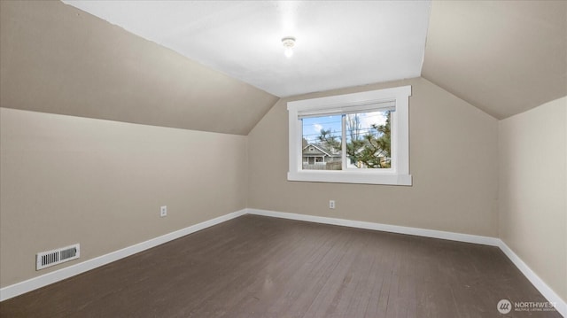 bonus room featuring vaulted ceiling, wood finished floors, visible vents, and baseboards