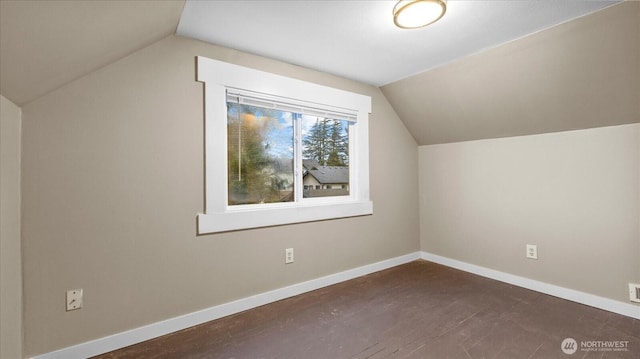 additional living space with lofted ceiling and baseboards