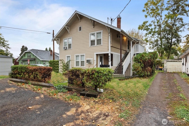 view of front of home with a chimney and stairway