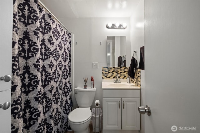 bathroom featuring toilet, backsplash, vanity, and a shower with curtain