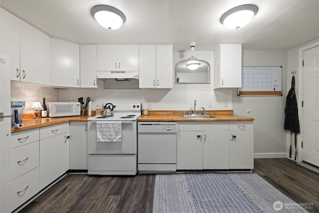 kitchen featuring butcher block counters, white cabinets, a sink, white appliances, and under cabinet range hood