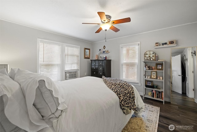 bedroom with dark wood-style floors, cooling unit, ornamental molding, and a ceiling fan