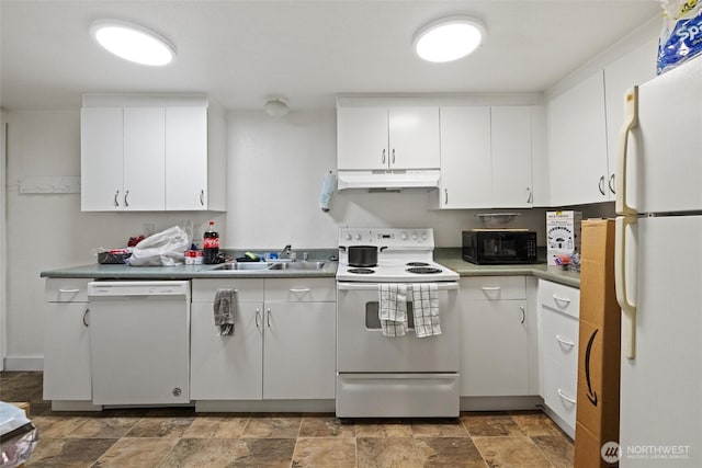 kitchen featuring stone finish flooring, white cabinets, a sink, white appliances, and under cabinet range hood