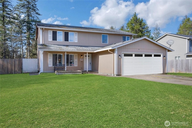 traditional-style house with covered porch, fence, aphalt driveway, and a front yard