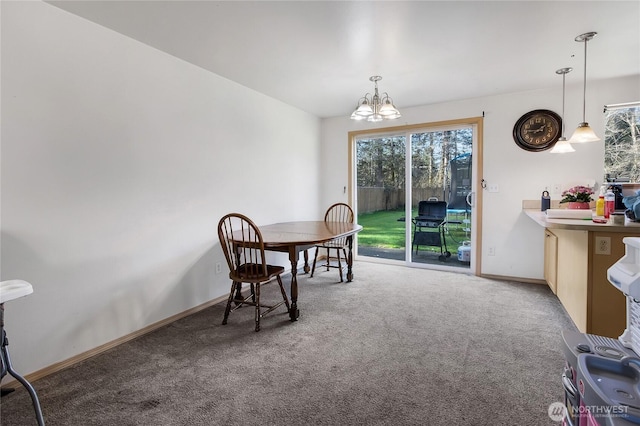 dining area with carpet, a chandelier, and baseboards