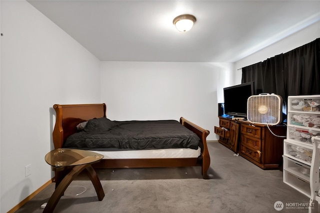 bedroom featuring carpet and baseboards