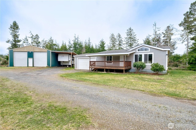 ranch-style house with an outdoor structure, a detached garage, driveway, a carport, and a front yard