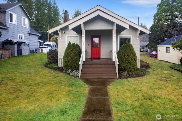 bungalow-style home featuring a chimney and a front lawn