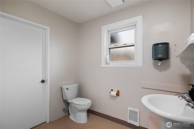 bathroom with visible vents, a sink, and toilet