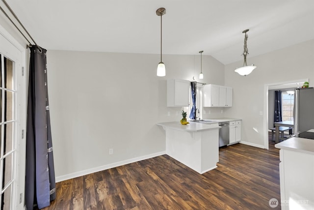 kitchen featuring light countertops, appliances with stainless steel finishes, white cabinetry, vaulted ceiling, and a sink