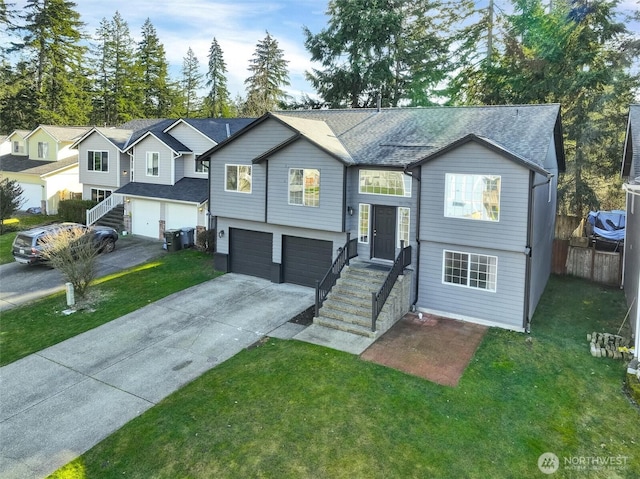 raised ranch featuring a garage, fence, concrete driveway, roof with shingles, and a residential view