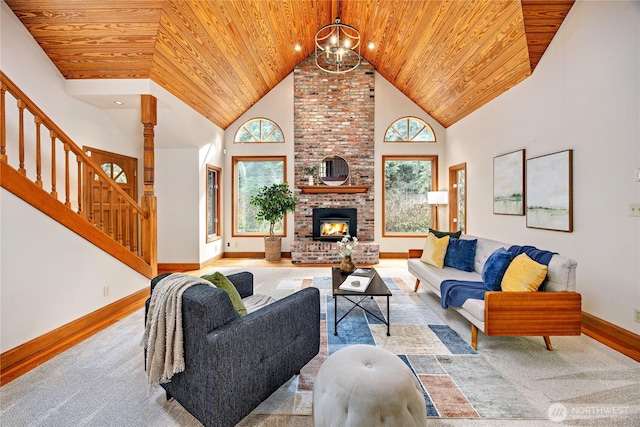 living area with high vaulted ceiling, wooden ceiling, a fireplace, and stairway