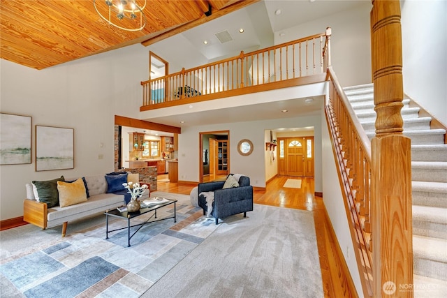 living area featuring wooden ceiling, recessed lighting, wood finished floors, baseboards, and stairway