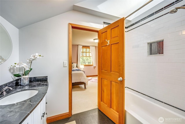 full bathroom with vaulted ceiling, tub / shower combination, vanity, and baseboards