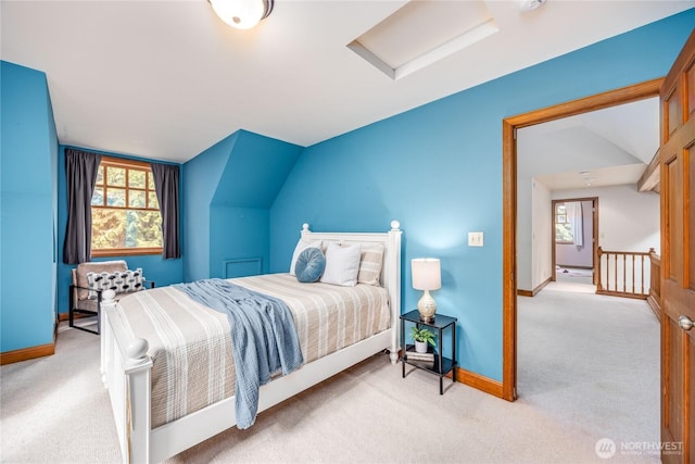 carpeted bedroom featuring attic access, vaulted ceiling, and baseboards