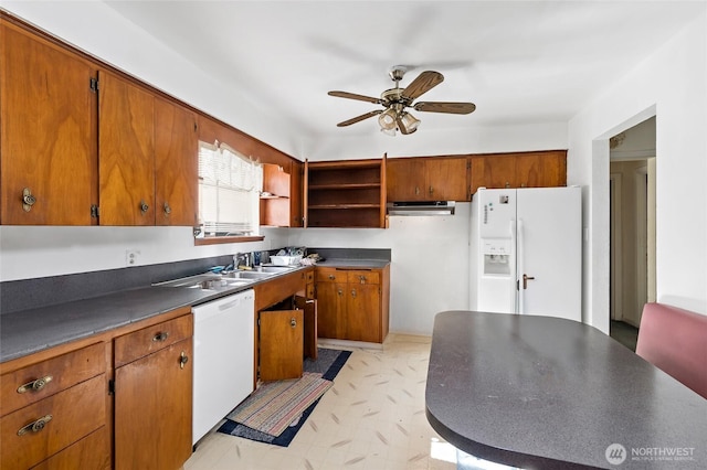 kitchen featuring brown cabinets, light floors, open shelves, dark countertops, and white appliances