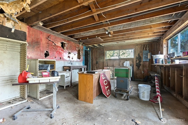 misc room featuring electric panel and a workshop area