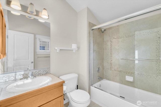 full bath with combined bath / shower with glass door, vanity, and toilet