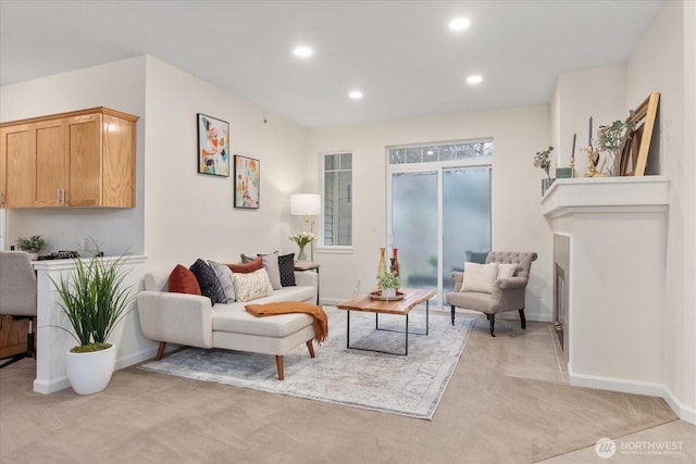 living room featuring light carpet, baseboards, and recessed lighting