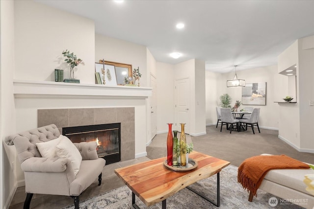 living room with carpet, recessed lighting, a tiled fireplace, and baseboards