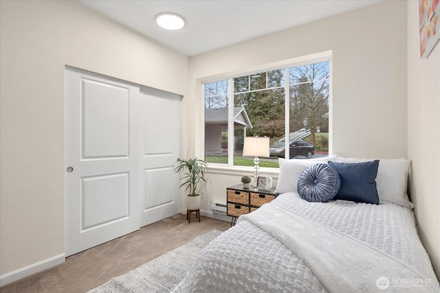 bedroom featuring carpet, a baseboard radiator, and baseboards