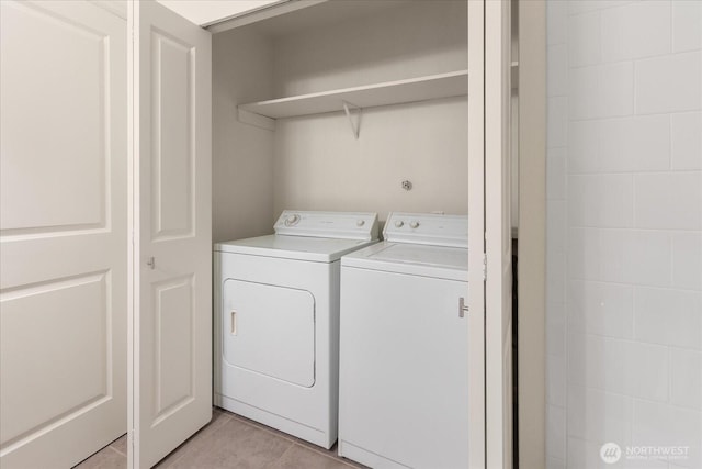 laundry area with laundry area, light tile patterned floors, and separate washer and dryer