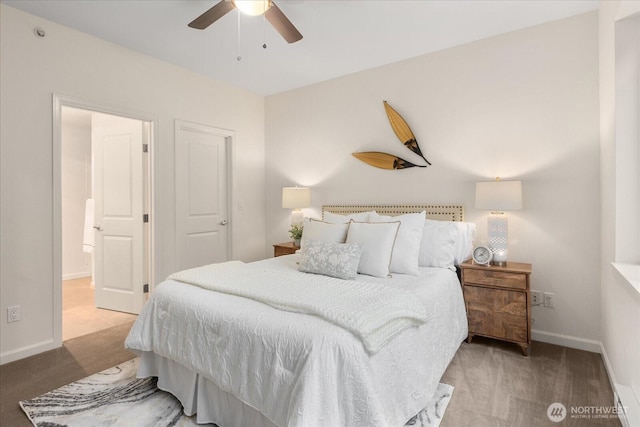 carpeted bedroom with ceiling fan and baseboards