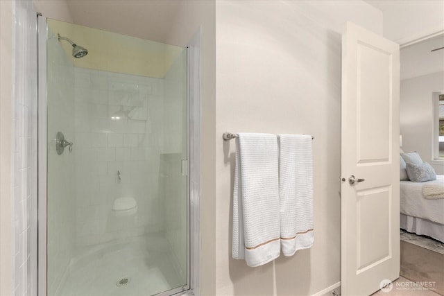 bathroom featuring a stall shower and ensuite bathroom