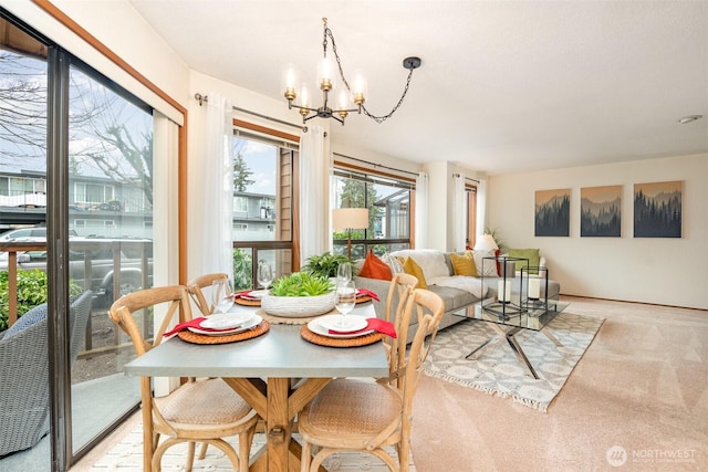 dining area featuring light carpet and an inviting chandelier