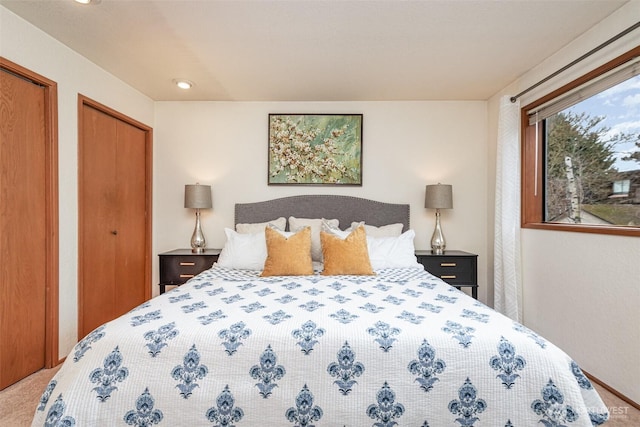 carpeted bedroom with multiple closets