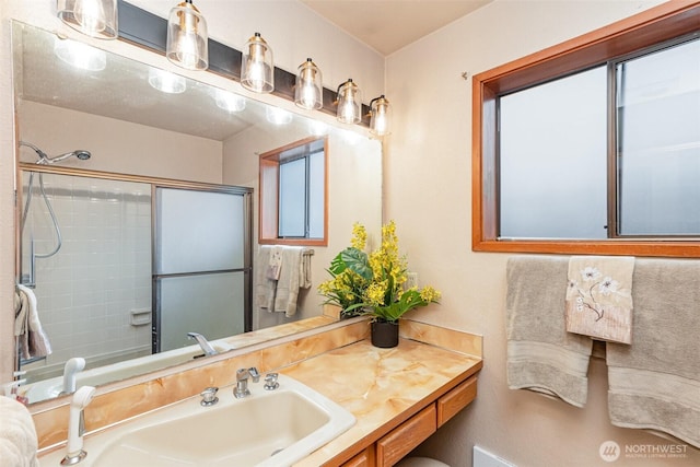 bathroom featuring walk in shower and vanity