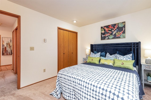 bedroom with carpet floors, a closet, and baseboards