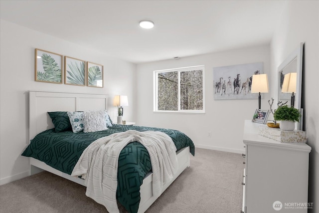 bedroom with light carpet and baseboards