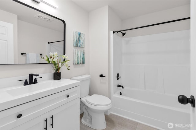 bathroom featuring shower / washtub combination, vanity, and toilet