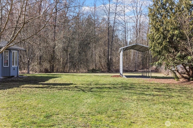 view of yard featuring a carport and a forest view